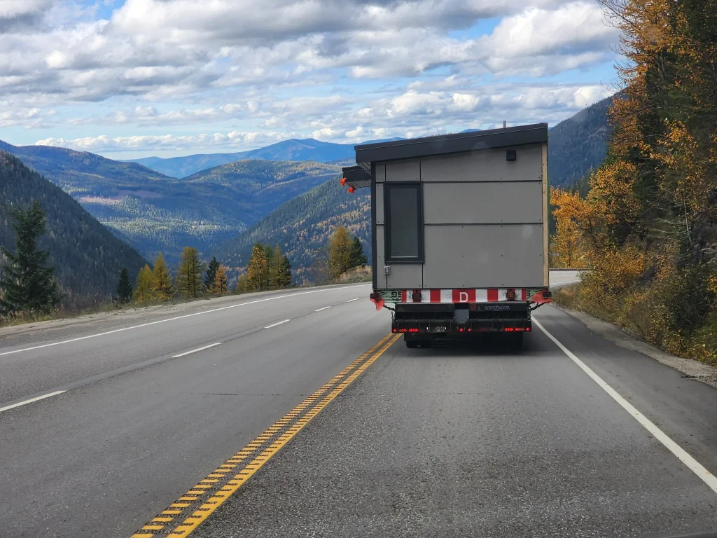 Modular building being transported on a truck bed